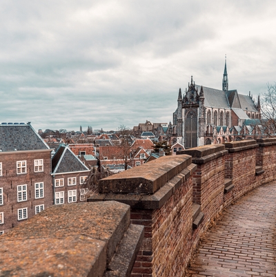<p>City image from a walkway, with a church and tall buildings in the background.</p>