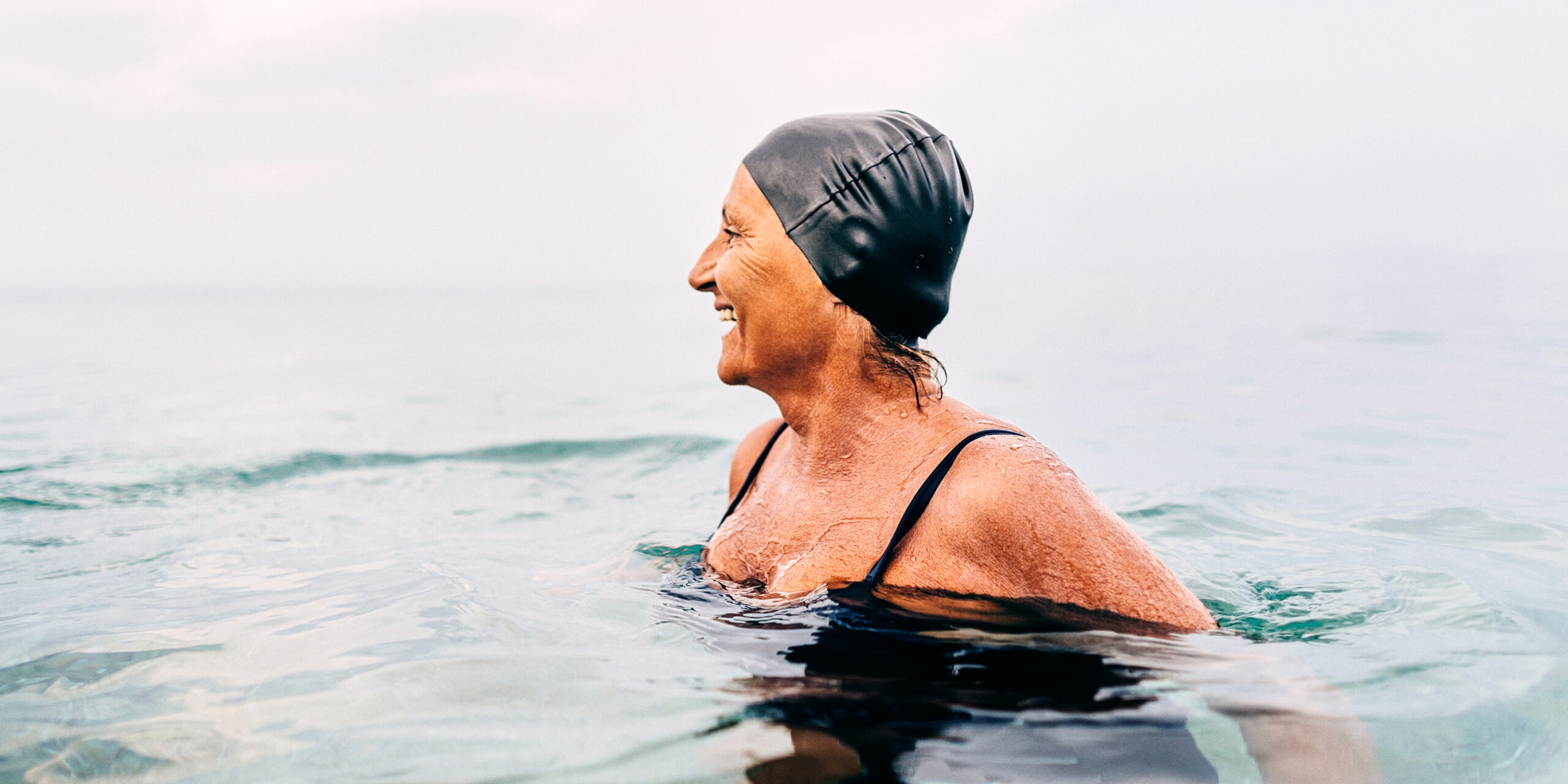 <p>Photo of a senior female swimmer in the sea</p>